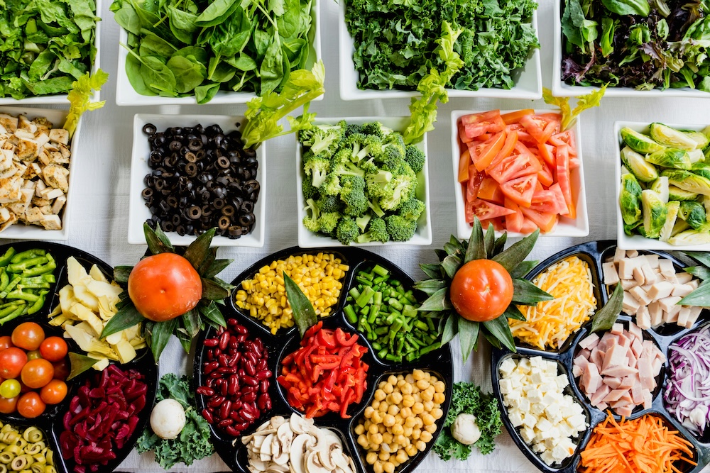 A vibrant Mediterranean spread with fresh vegetables, olive oil, and herbs